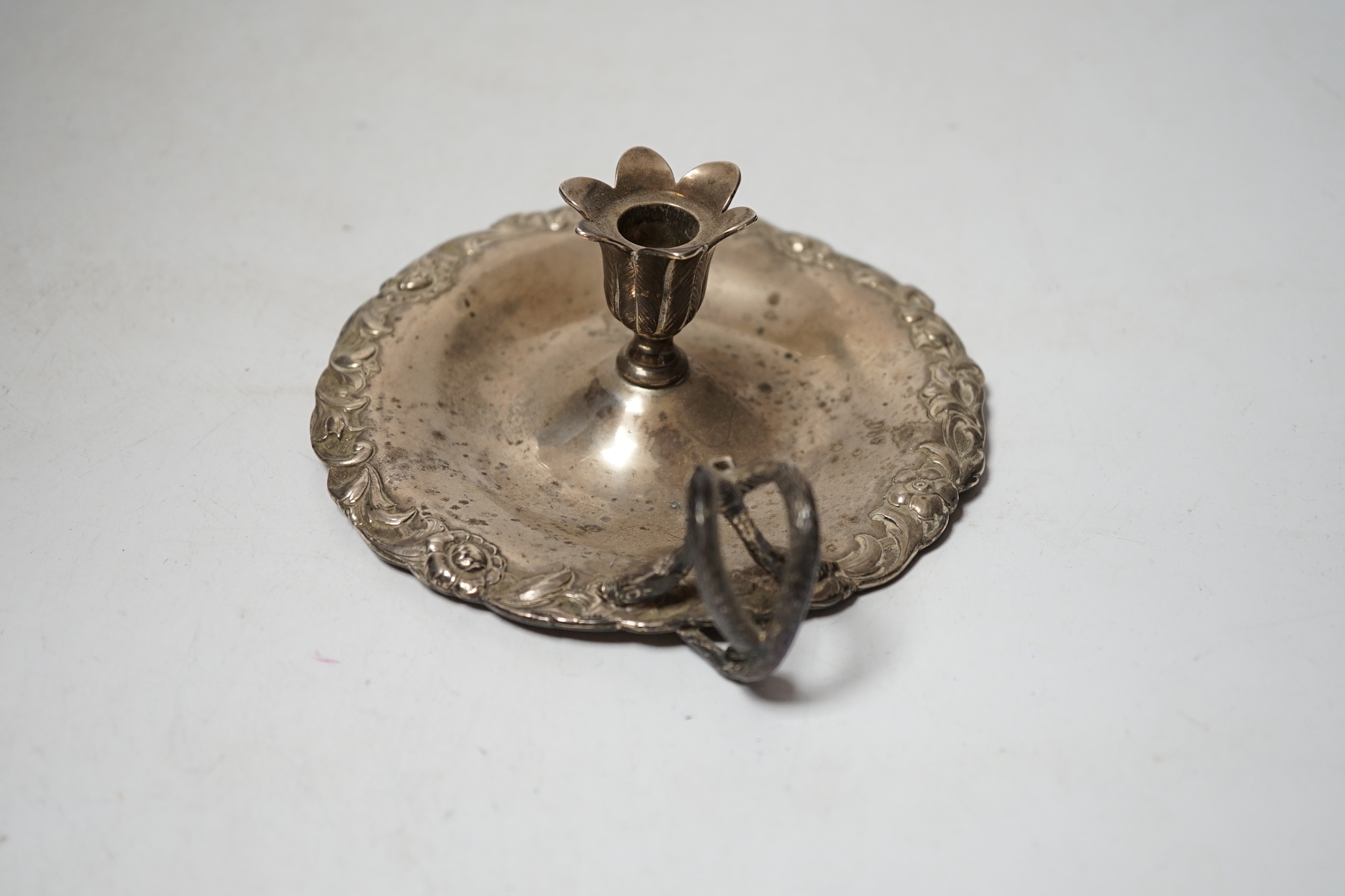 An early Victorian silver chamberstick, Robert Hennell III, London, 1842, with foliate border, 13.8cm, lacking snuffer, 5.9oz.